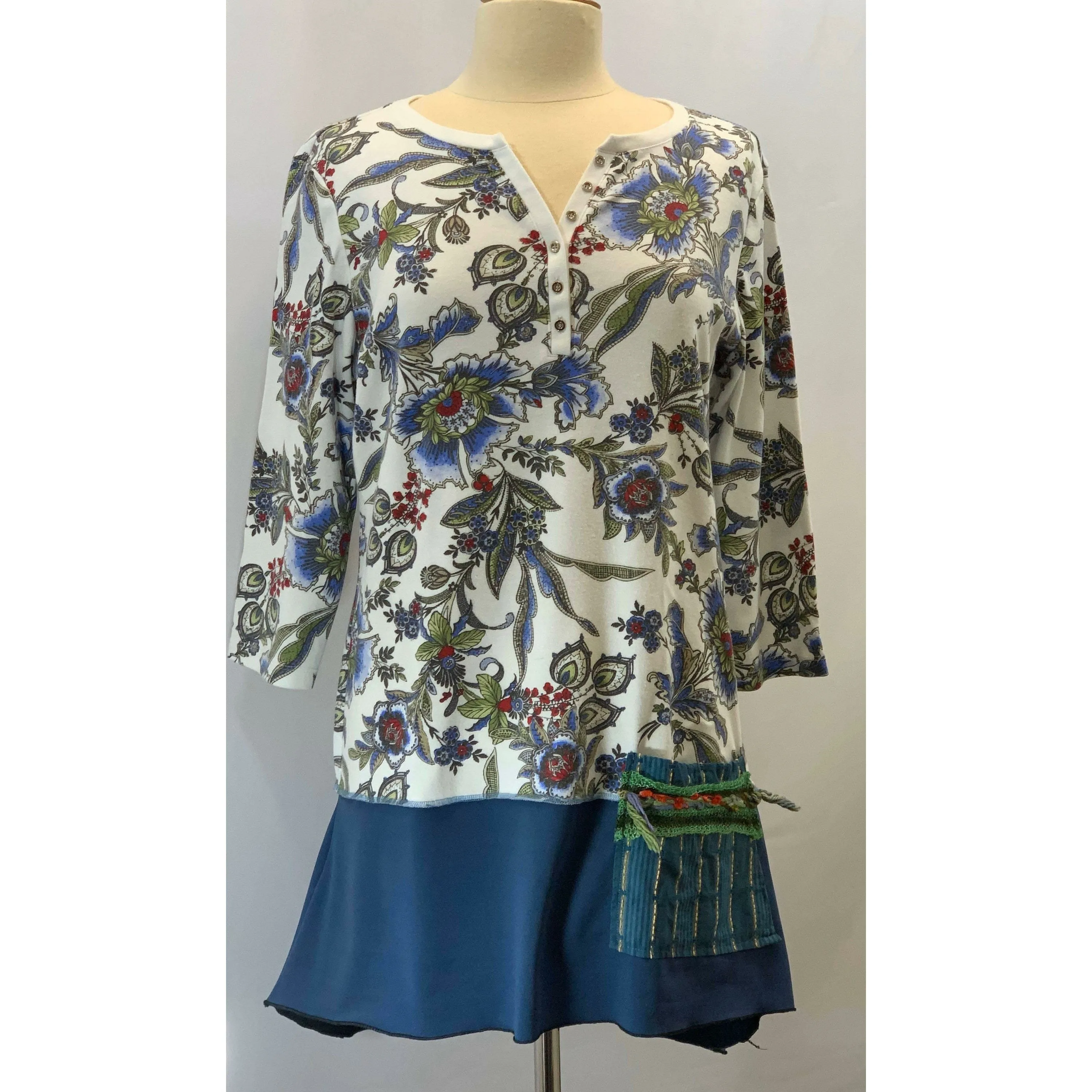 Blue Floral repurposed top into a new tunic size Large. The neckline has snaps to hold in place. The fabric on the bottom is new polyester.