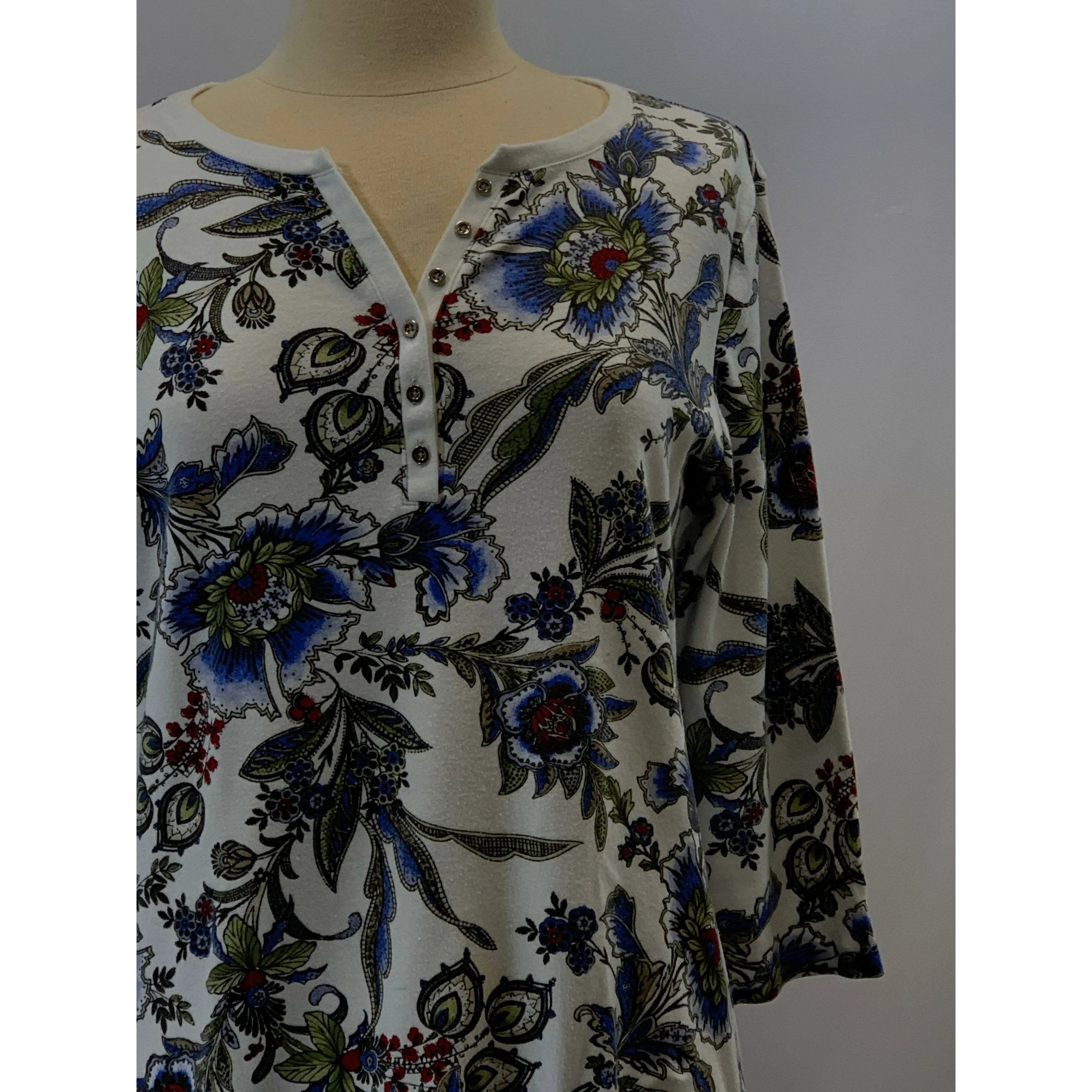 Blue Floral repurposed top into a new tunic size Large. The neckline has snaps to hold in place. The fabric on the bottom is new polyester.