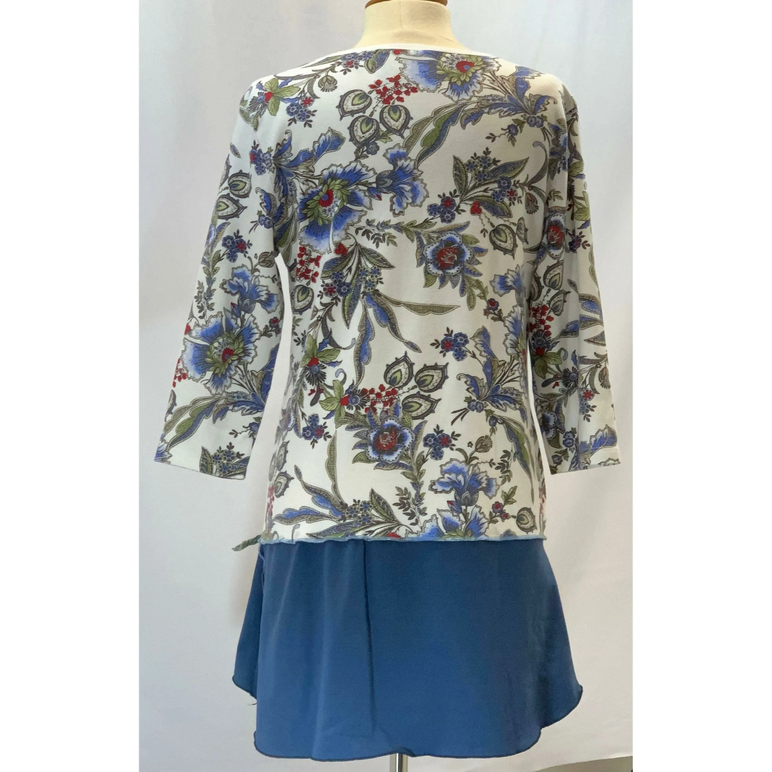 Blue Floral repurposed top into a new tunic size Large. The neckline has snaps to hold in place. The fabric on the bottom is new polyester.